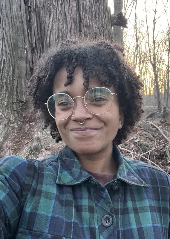 Izabelle Jaquet smiling in front of tree