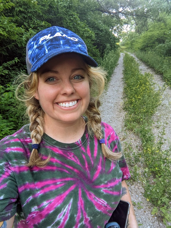 Abby Pagels smiling in front of dirt road