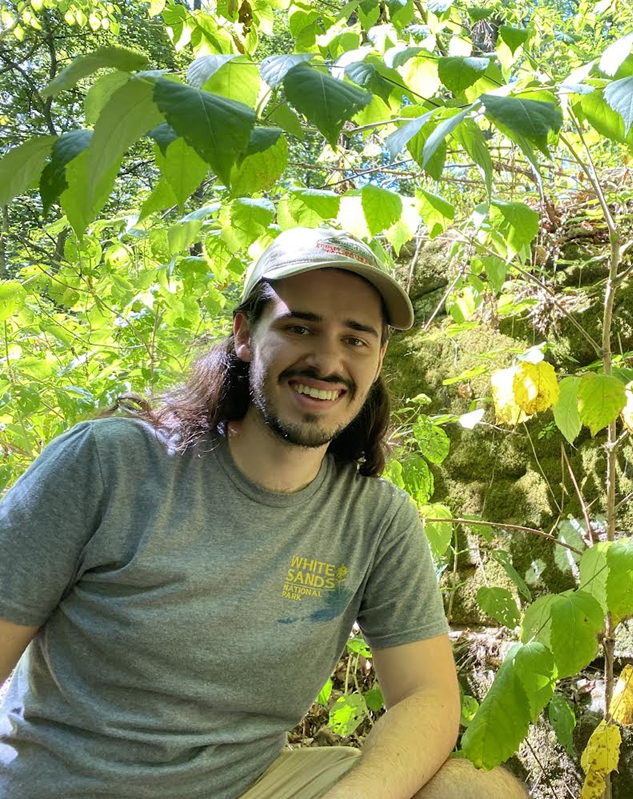 Ricky Gieser smiling in front of plants
